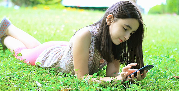 Little Girl Playing Video Games On Smartphone By Marianst VideoHive